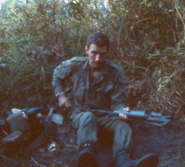 Pl Comd Lt Bill Blair doing weapon maintenance on M16 rifle [King]