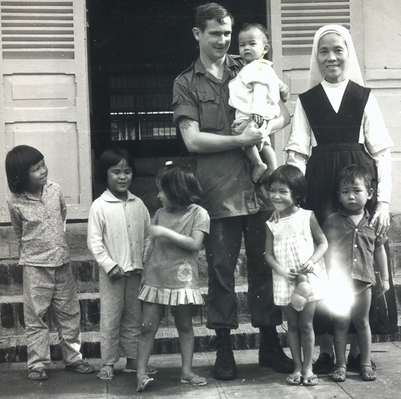 Cpl Baden Ewart with orphans & nun, Baria Orphanage 1970 or early 1971 [Young]